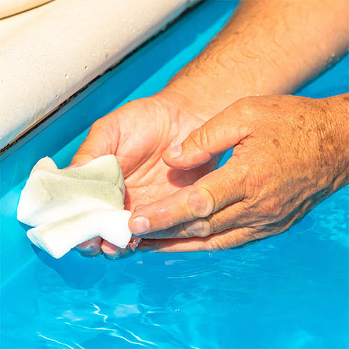 Pool skimmer basket being cleaned